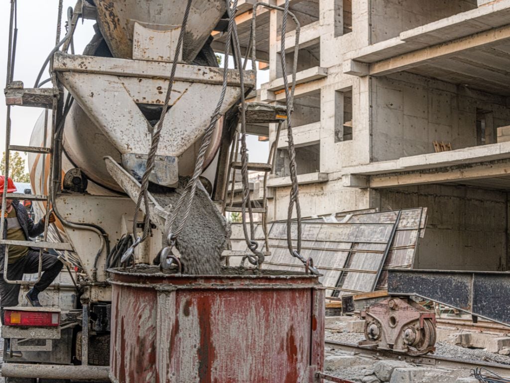 Concrete poured into bucket at construction site