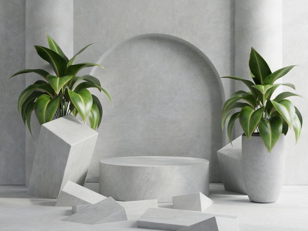 Minimalist concrete podium with geometric blocks and potted plants