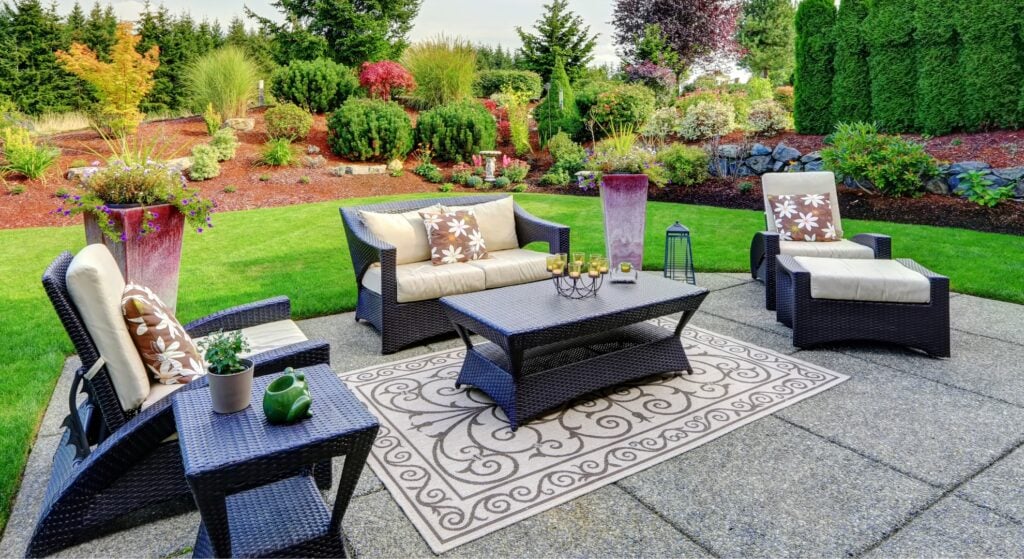 Outdoor patio with wicker lounge and landscaped garden