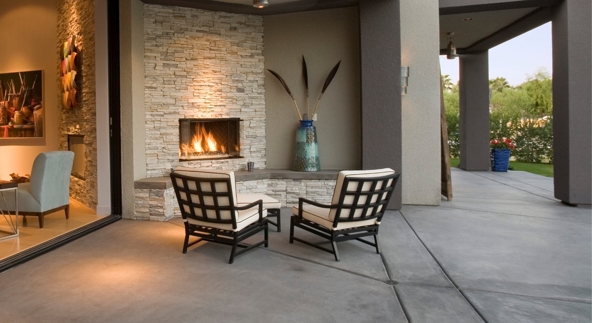 Concrete patio and chair in front of a fireplace