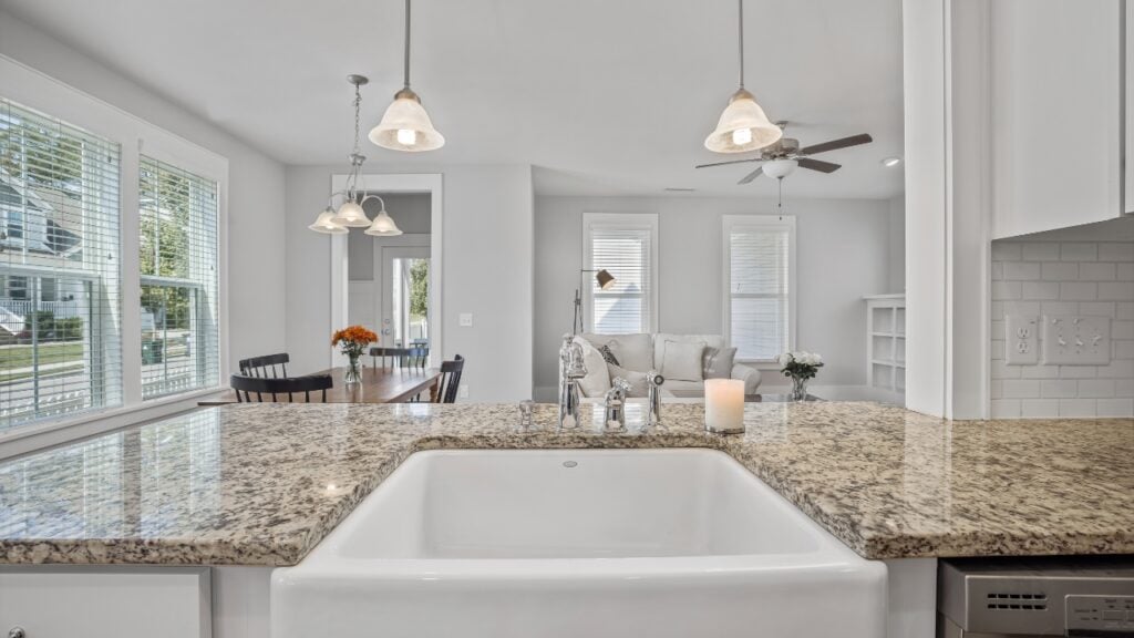 Modern kitchen with granite island overlooking living area