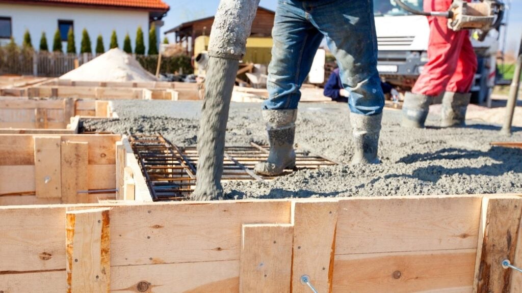 Concrete being poured for foundation slab on construction site