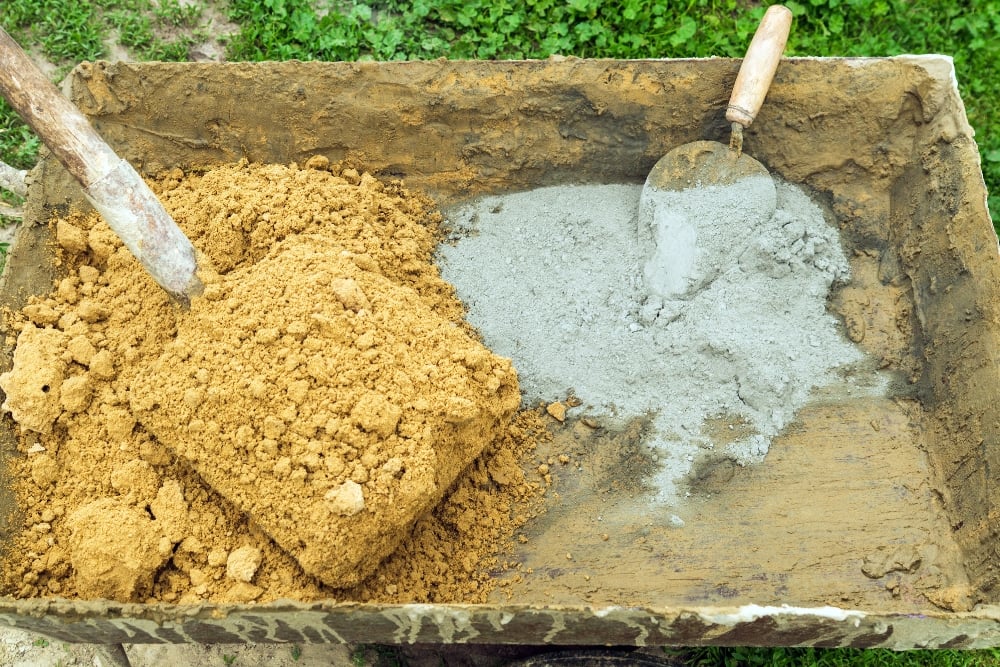 Wheelbarrow with sand and cement for mixing
