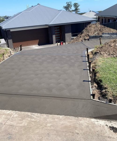 Freshly poured concrete driveway at suburban home