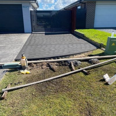 Fresh concrete driveway with modern sliding gate