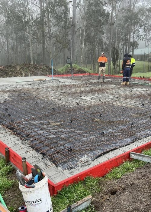 Concrete slab pour with steel reinforcement in bushland
