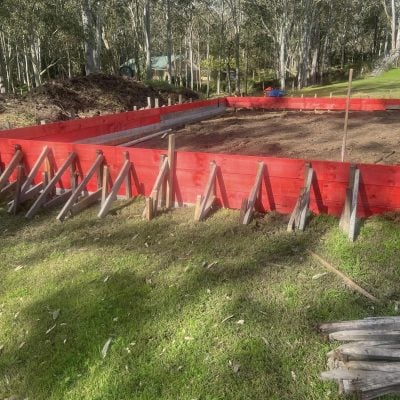 Red timber formwork for concrete slab in bushland