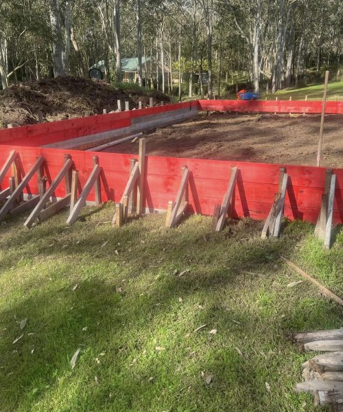Red timber formwork for concrete slab in bushland