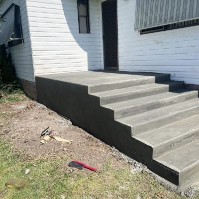 New concrete steps and landing at house entrance