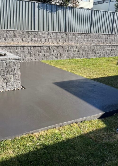 New concrete slab beside tiered retaining walls