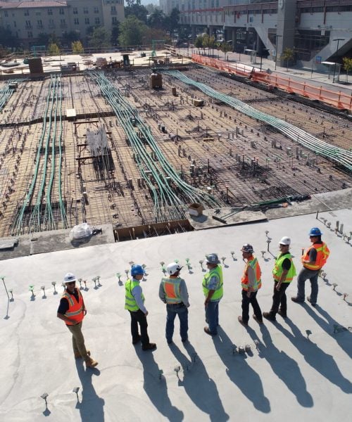 Site team inspecting concrete slab prep for shed and garage build