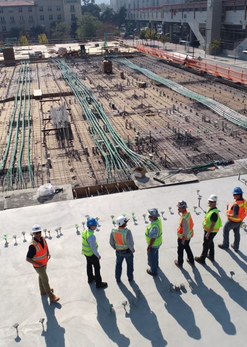 Site team inspecting concrete slab prep for shed and garage build